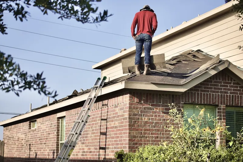Professional roofer working on a residential roof in Cedar Grove-Lynbrook